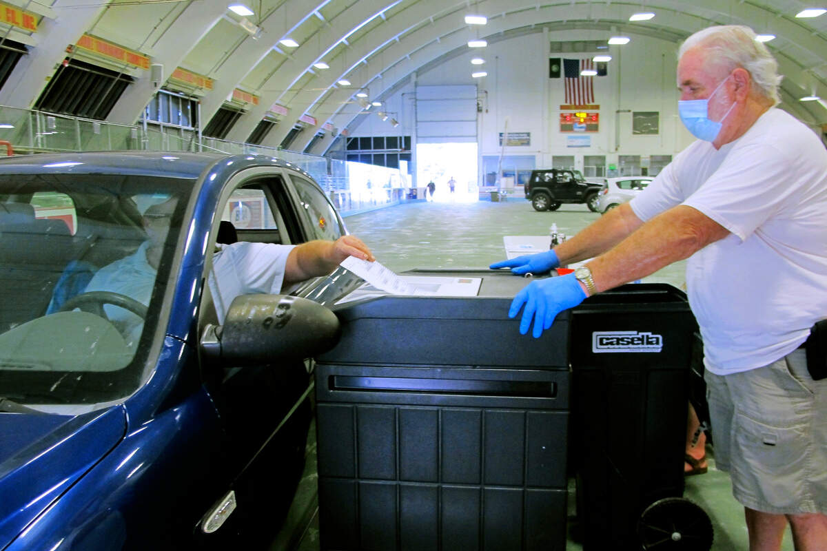 A voter casts a ballot in Vermont’s statewide primary on Tuesday, Aug. 11, 2020, in Barre, Vt. The city provided drive-thru voting in the Barre Civic Center. (AP Photo/Lisa Rathke)