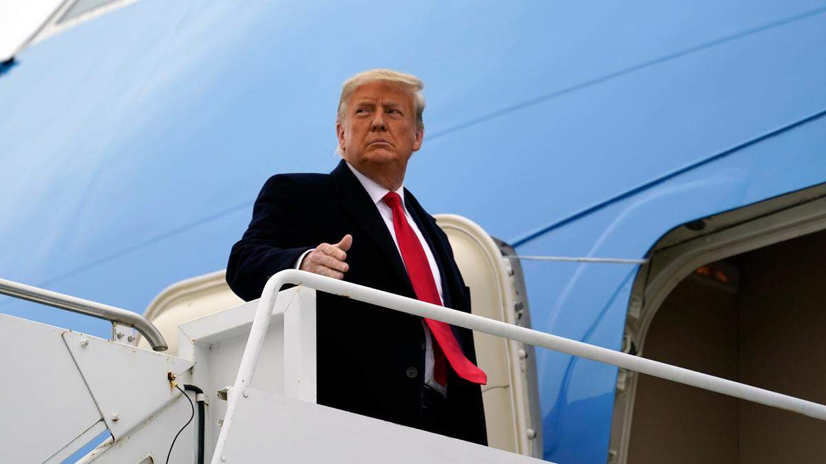 Former President Donald Trump gestures as he boards Air Force One upon arrival at Valley International Airport, Tuesday, Jan. 12, 2021, in Harlingen, Texas, after visiting a section of the border wall with Mexico in Alamo, Texas. (AP Photo/Alex Brandon)