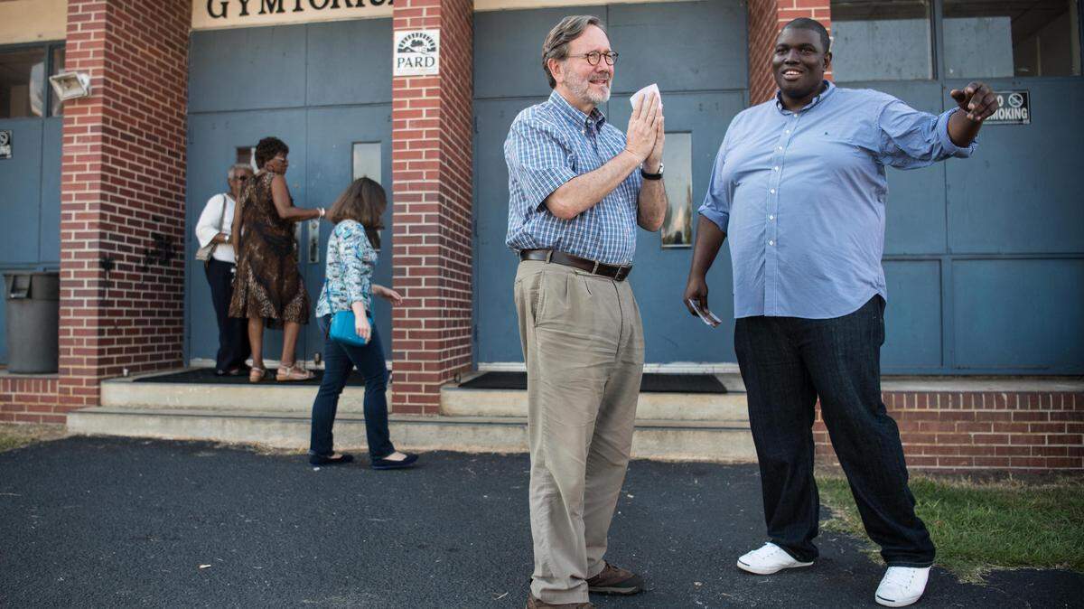 Democratic nominee for South Carolina’s Fifth Congressional District Archie Parnell, left, and campaign manager Terrence Culbreth talk with voters during a fish fry at the old Bishopville High School Aug. 9, 2018, in Bishopville, S.C. The event kicked off Parnell’s eleven county “Truth Tour,” drumming up support in hopes of defeating incumbent Rep. Ralph Norman, R-S.C.
