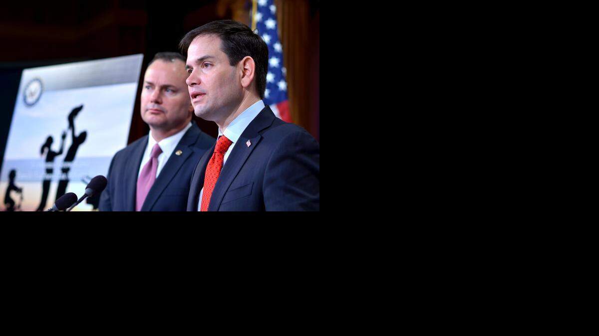 U.S. Sens. Mike Lee of Utah and Marco Rubio of Florida discuss an overhaul of the nation's corporate and individual tax systems during a Washington press conference March 4, 2015. Their proposal, which has not yet formally been introduced to Congress, would cut corporate tax rates and flatten the number of individual tax brackets.
