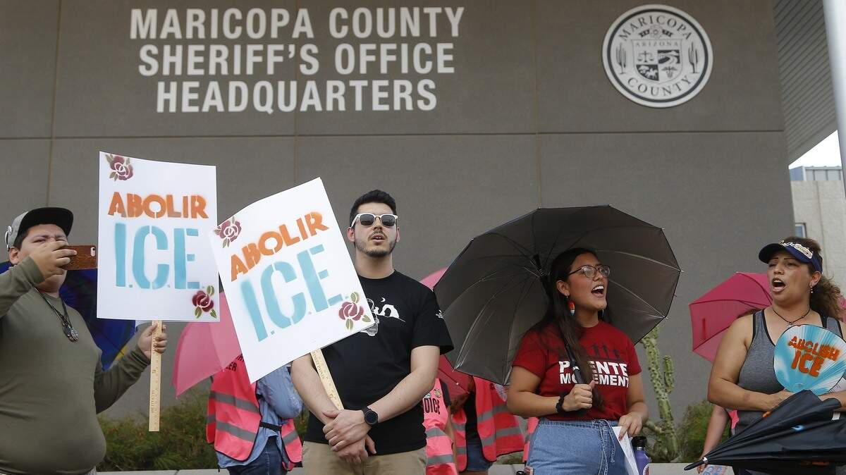 Immigration activists protest against the Maricopa County Sheriff and Immigration and Customs Enforcement at the county jail  Wednesday, Aug. 22, 2018, in Phoenix.