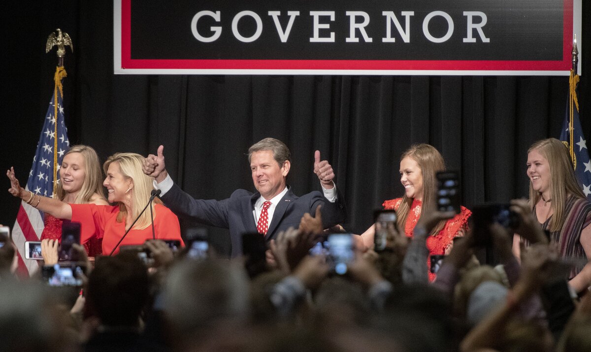 Republican gubernatorial candidate Brian Kemp walks on stage with his family before speaking to his supporters early Wednesday morning during a campaign watch party in downtown Athens.