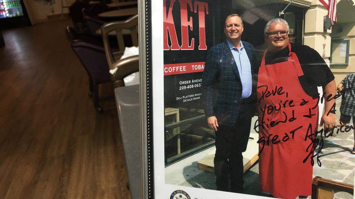 Dave Lopez, a former councilman and owner of Sam and Dave’s Market in Modesto, has a picture of him and Rep. Jeff Denham together by his register. Lopez says he will continue to support Denham this year, though other members of the Hispanic community have given him flack for it.