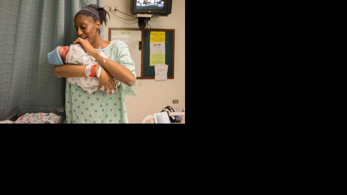 Bionka Burkhalter practices speaking to her baby at the maternity ward at the University of Chicago Medical Center on Oct. 14, 2014.
