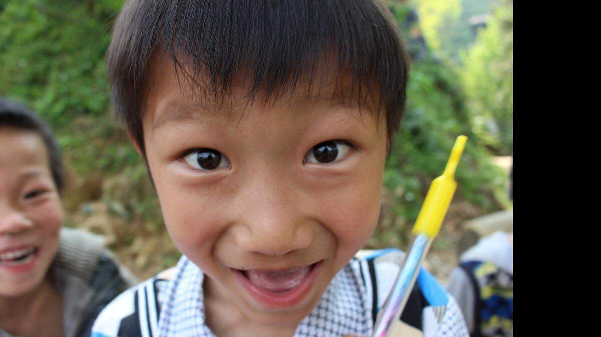 A Miao boy jumps in to get a closer look at a camera lens in Kong Ming village, near Rongjiang in Guizhou province, China on April 4, 2015. The Miao, who are related to the Hmong in other parts of Asia, have farmed terraced rice paddies in this part of China for hundreds of years. Residents of this village say they rarely see foreign visitors.
