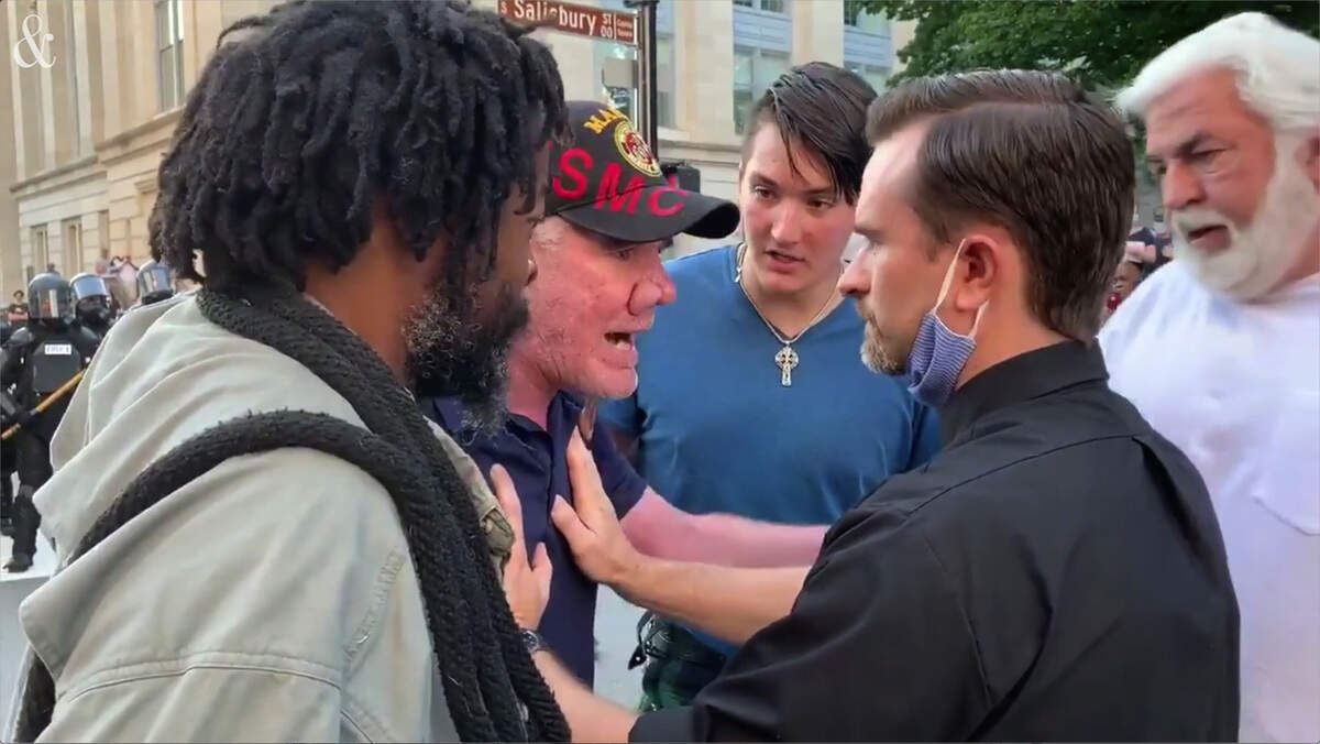 The News & Observer’s Ashad Hajela recorded a man wearing a priest’s collar trying to calm a counter-protester. The counter-protester had been shouting at protesters near the North Carolina State Capitol in Raleigh.