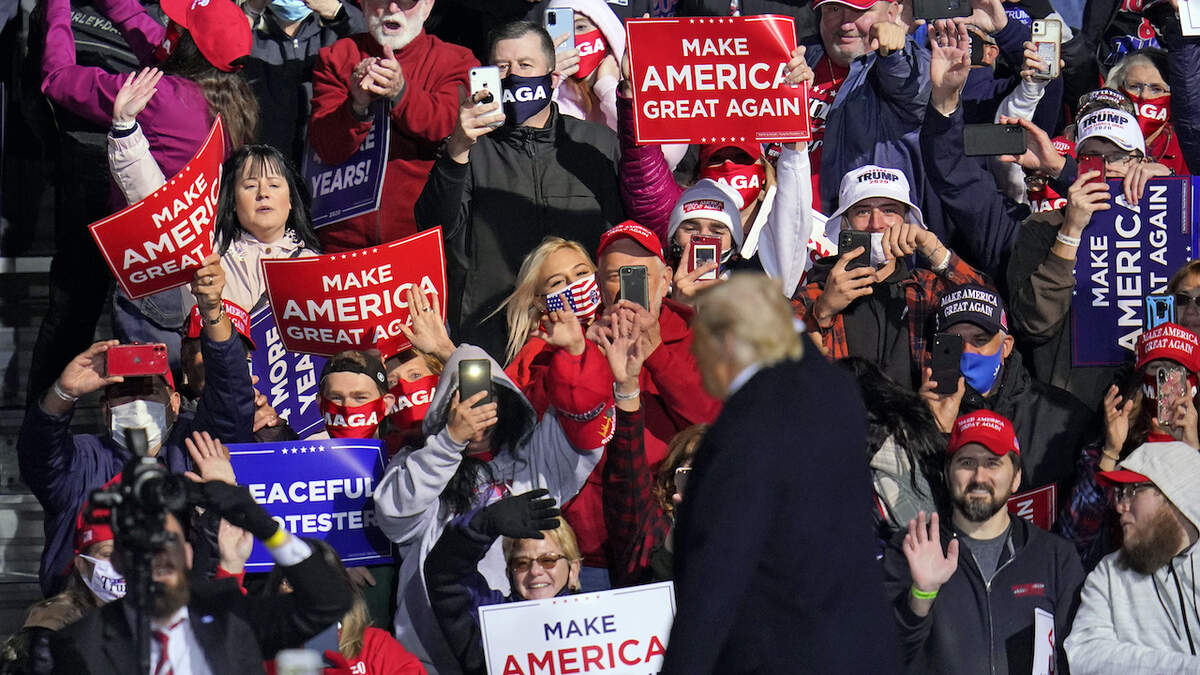 Supporters cheer as President Donald Trump departs a campaign rally at John P. Murtha Johnstown-Cambria County Airport in Johnstown, Pa., Tuesday, Oct. 13, 2020. (AP Photo/Gene J. Puskar)