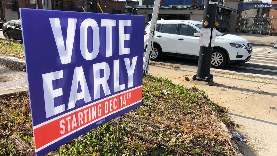 A sign in an Atlanta neighborhood on Friday, Dec. 11, 2020, urges people to vote early in Georgia’s two U.S. Senate races. Turnout in the state’s pair of runoffs has broken records.