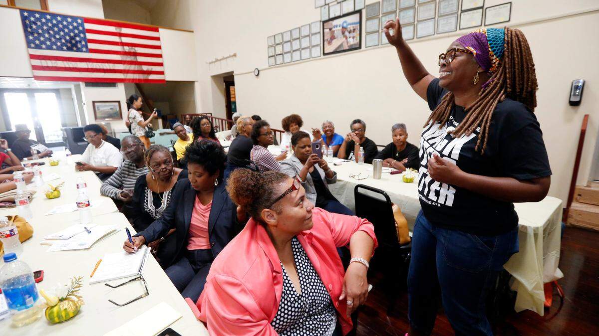 LaTosha Brown, right, co-founder of Black Voters Matter, breaks out with an organizing song at a meeting of several Mississippi grassroots organizations in Greenville, Mississippi, Aug. 24, 2018.