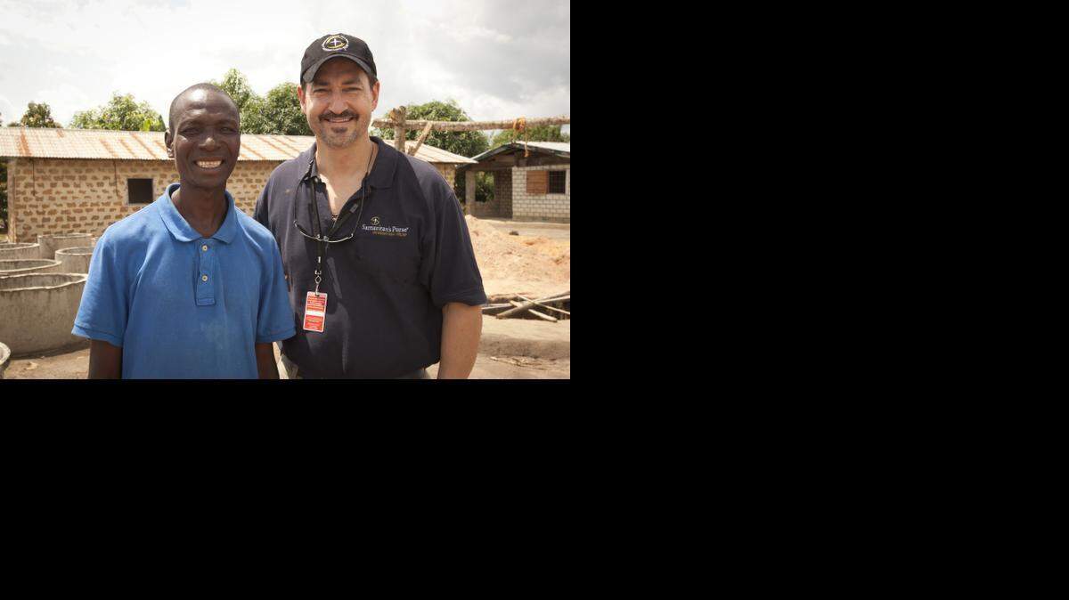 Dr. Lance Plyler from Samaritan's Purse is pictures with an Ebola survivor in Liberia on June 29, 2014.
