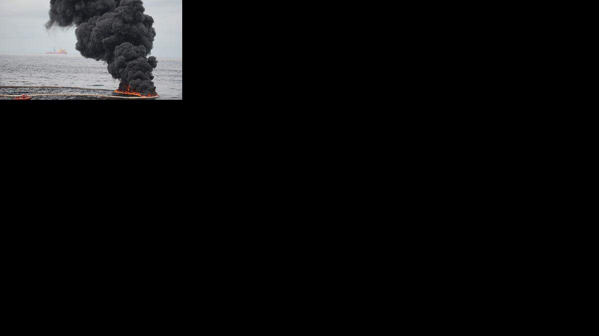 Gathered concentrated oil burns during a controlled oil fire in the Gulf of Mexico.