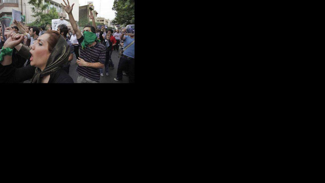 Supporters of reformist candidate Mir Hossein Mousavi, some wearing green as the color of the party, gather on the streets protesting the results of the Iranian presidential election in Tehran, Iran, Saturday, June 13, 2009. Iranian riot police have clashed with supporters of the main opposition candidate in disputed presidential elections. (AP Photo/Ben Curtis)