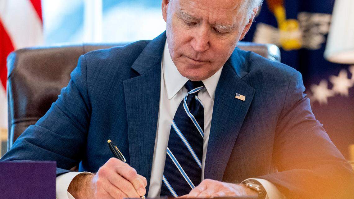 President Joe Biden signs the American Rescue Plan, a coronavirus relief package, in the Oval Office of the White House, Thursday, March 11, 2021, in Washington. (AP Photo/Andrew Harnik)