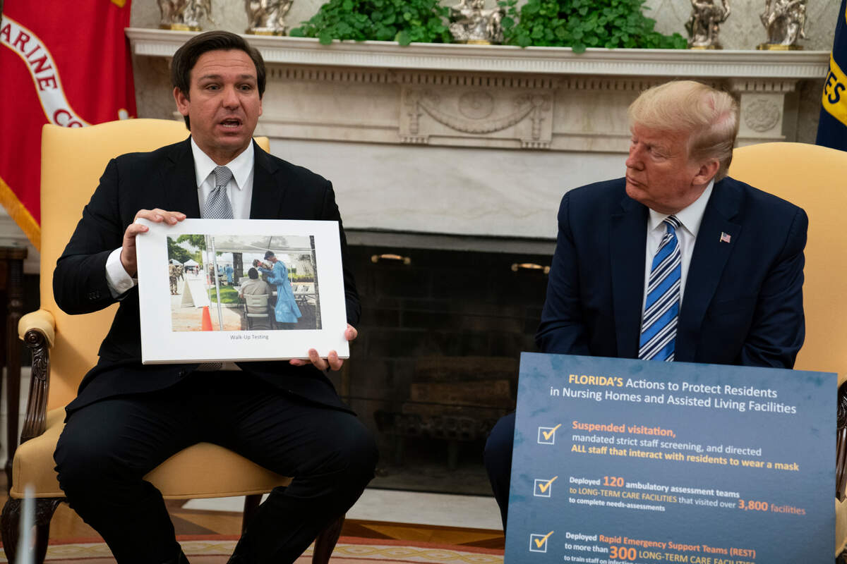 President Donald Trump listens as Gov. Ron DeSantis, R-Fla., talks about the coronavirus response during a meeting in the Oval Office of the White House, Tuesday, April 28, 2020, in Washington. (AP Photo/Evan Vucci)
