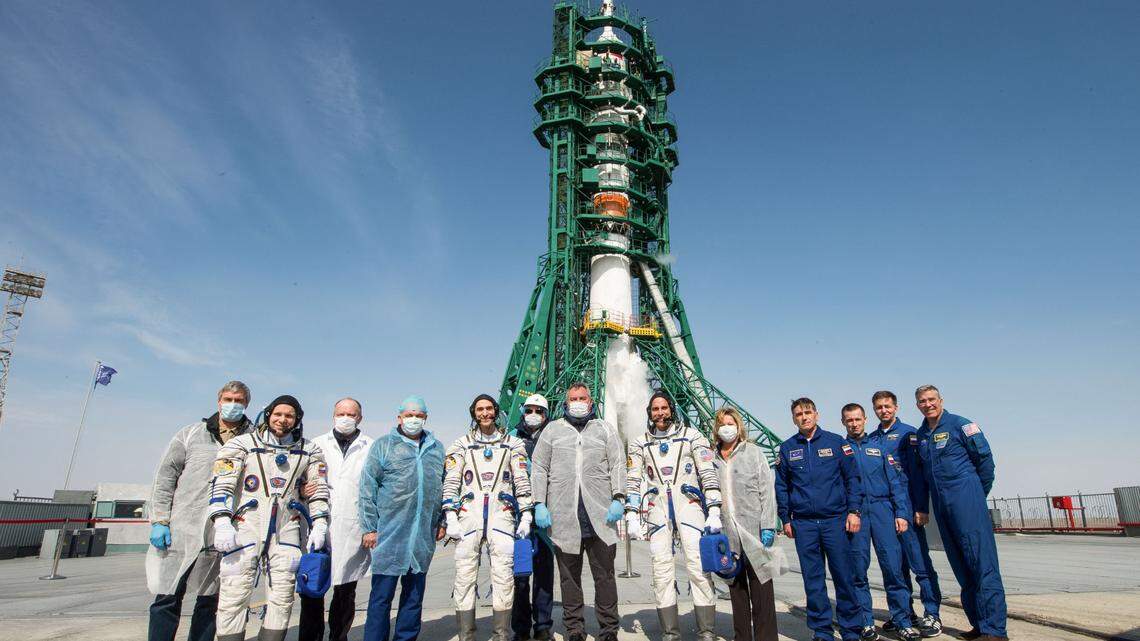 Expedition 63 crew members Ivan Vagner of Roscosmos, Anatoly Ivanishin of Roscosmos, and Chris Cassidy of NASA pose for a group photograph with Roscosmos Director Gen. Dmitry Rogozin, center, mission management and the backup crew at the launch pad, Thursday, April 9, 2020.