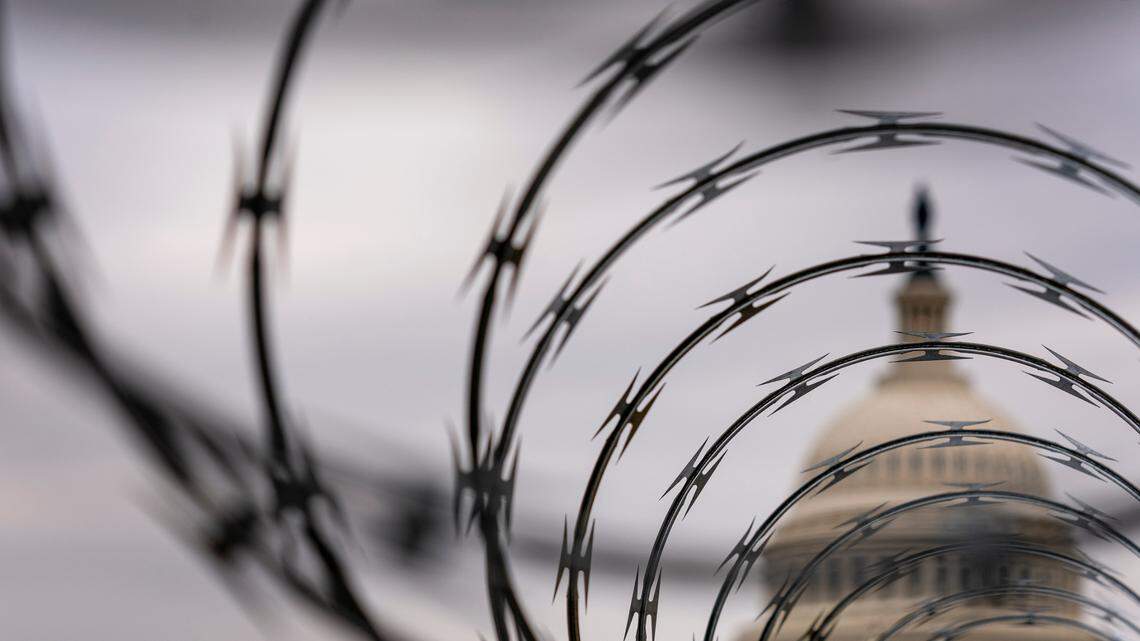 Razor wire covered fencing is visible outside the U.S. Capitol during the second impeachment trial of former President Donald Trump in Washington, Wednesday, Feb. 10, 2021. (AP Photo/Andrew Harnik)