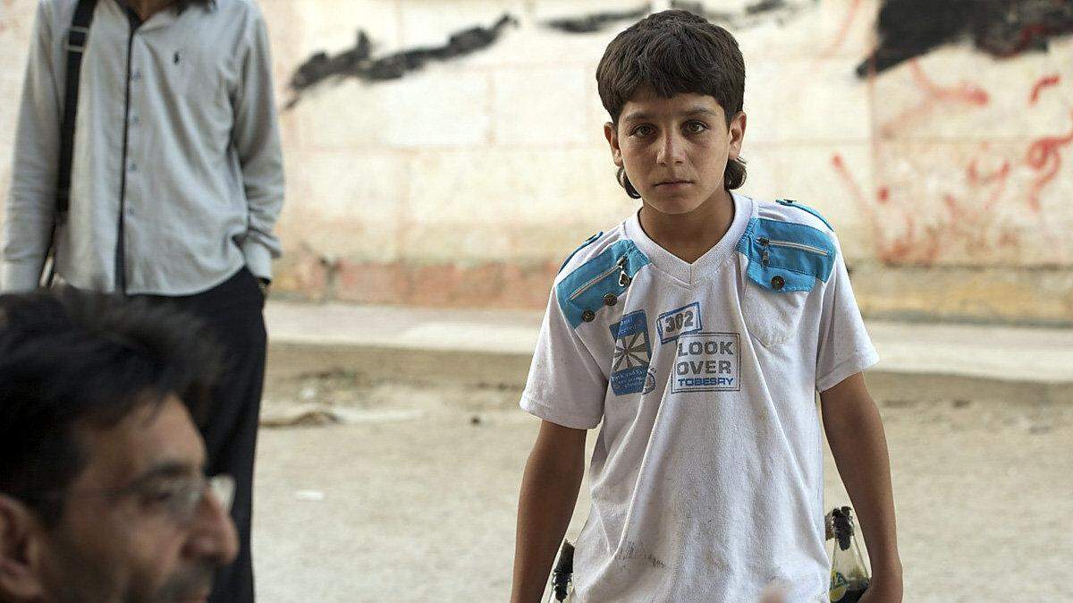 A June 3 photo taken by Austin Tice in Syria shows a 15-year-old boy holding two Molotov cocktails he hoped to employ against government forces.