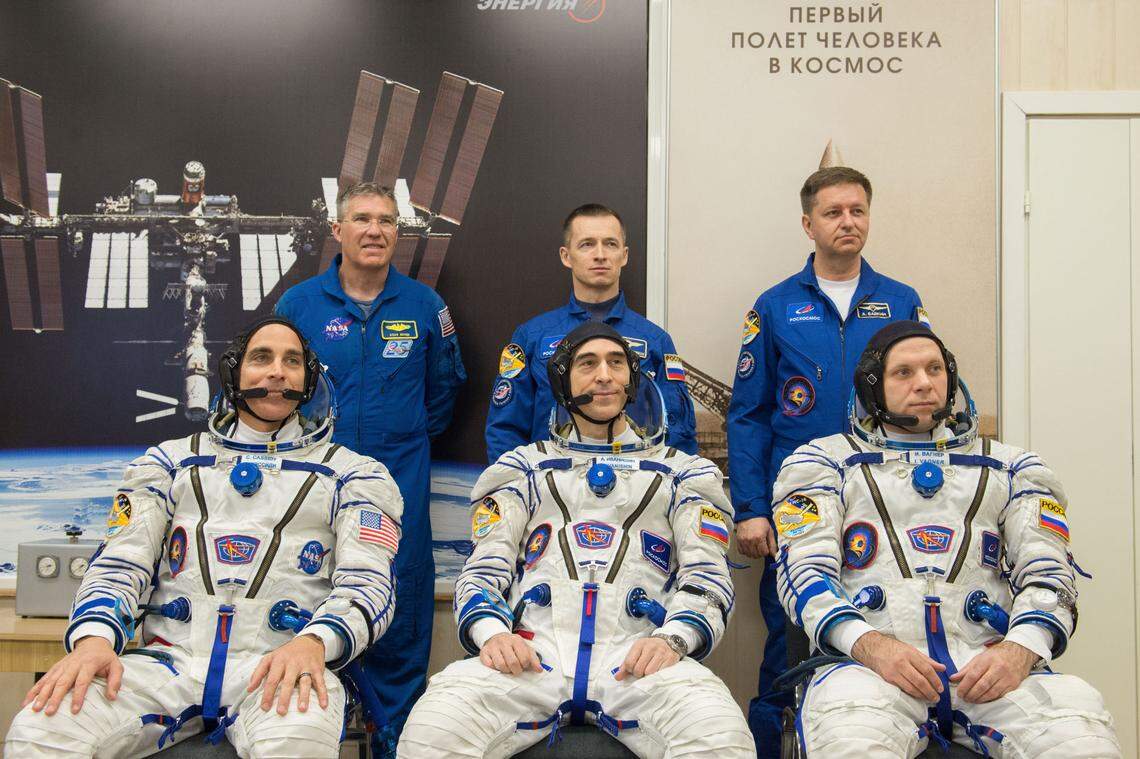 Expedition 63 crew members Chris Cassidy of NASA, seated left, and Anatoly Ivanishin and Ivan Vagner of Roscosmos, seated right, pose for a photo with backup crew members Steve Bowen of NASA, standing left, and Sergey Ryzhikov and Andrei Babkin of Roscosmos, standing right, after the crew had its Sokol suits pressure checked prior to launch on a Soyuz rocket, Thursday, April 9, 2020.