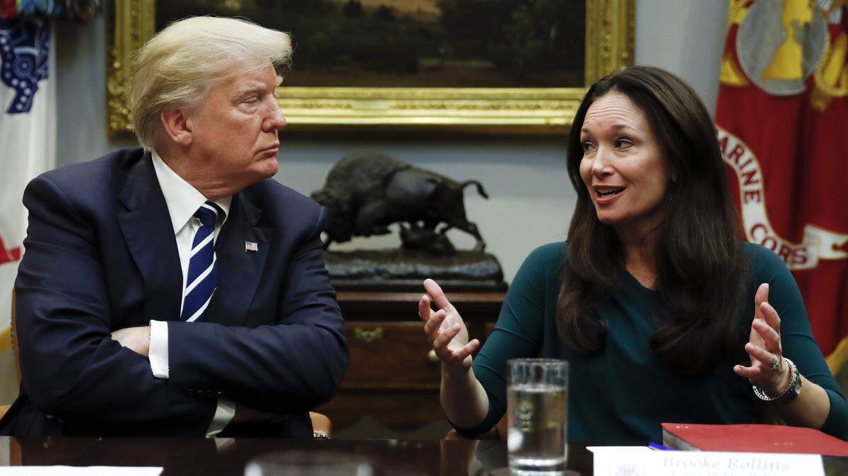 President Donald Trump, left, looks to Brooke Rollins, right, as she speaks during a prison reform roundtable in the Roosevelt Room of the Washington, Thursday, Jan. 11, 2018.