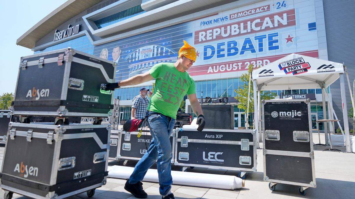 David Lucas, with IATSE Local 18 from Milwaukee, works on moving stage gear into place as work is done Tuesday outside Fiserv Forum in preparation for the Aug. 23 Republican presidential debate in Milwaukee.