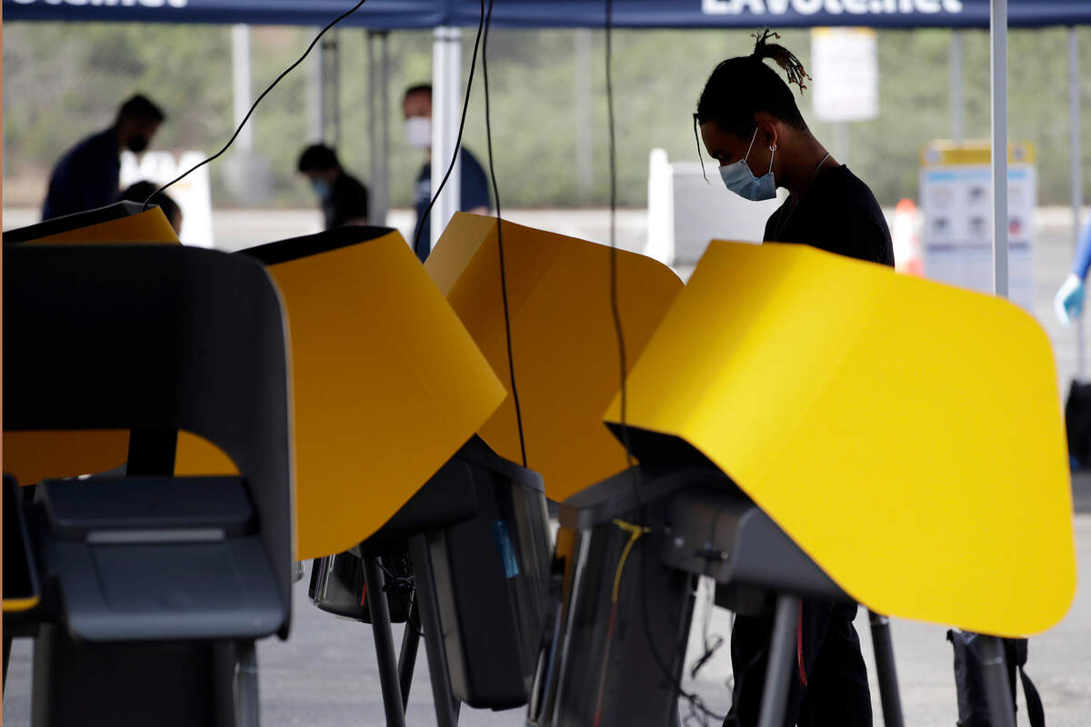 Voters wear masks during a special election for California’s 25th Congressional District seat Tuesday, May 12, 2020, in Santa Clarita, Calif. Republican Mike Garcia and Democrat Christy Smith are running for the seat after the resignation of Rep. Katie Hill, D-Calif. (AP Photo/Marcio Jose Sanchez)