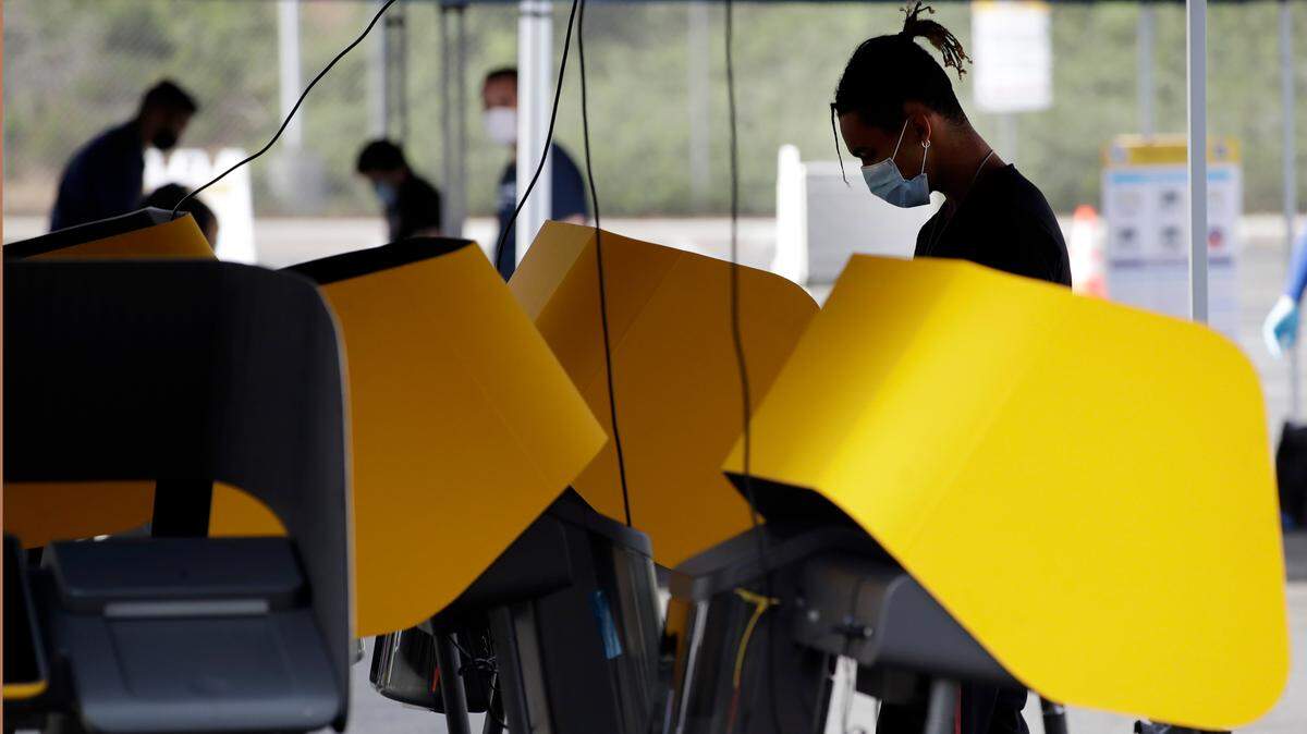 Voters wear masks during a special election for California’s 25th Congressional District seat Tuesday, May 12, 2020, in Santa Clarita, Calif. Republican Mike Garcia and Democrat Christy Smith are running for the seat after the resignation of Rep. Katie Hill, D-Calif. (AP Photo/Marcio Jose Sanchez)