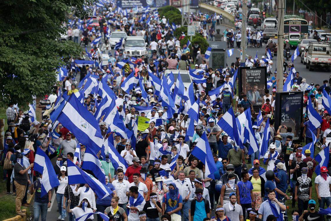 People march with Nicaraguan national flags during the commemoration of Student Day, demanding the ouster of President Daniel Ortega and the release of political prisoners, in Managua, Nicaragua, on Monday, July 23, 2018. Anti-government protests began in mid-April over cuts to the social security system but broadened to include demands for Ortega to leave office and early elections to be held.