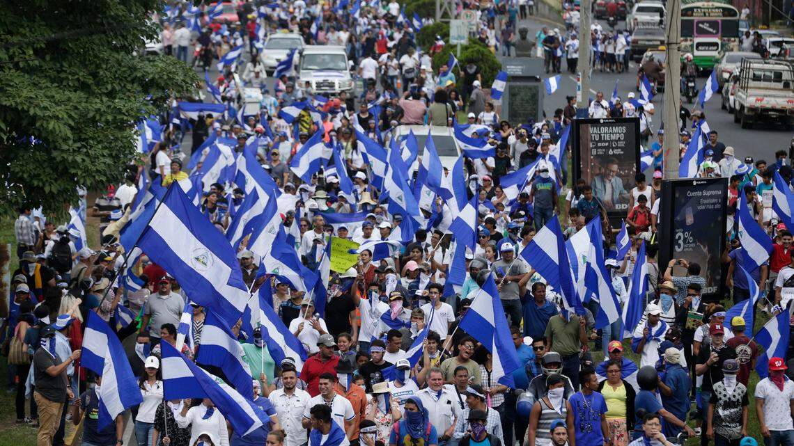 People march with Nicaraguan national flags during the commemoration of Student Day, demanding the ouster of President Daniel Ortega and the release of political prisoners, in Managua, Nicaragua, on Monday, July 23, 2018. Anti-government protests began in mid-April over cuts to the social security system but broadened to include demands for Ortega to leave office and early elections to be held.
