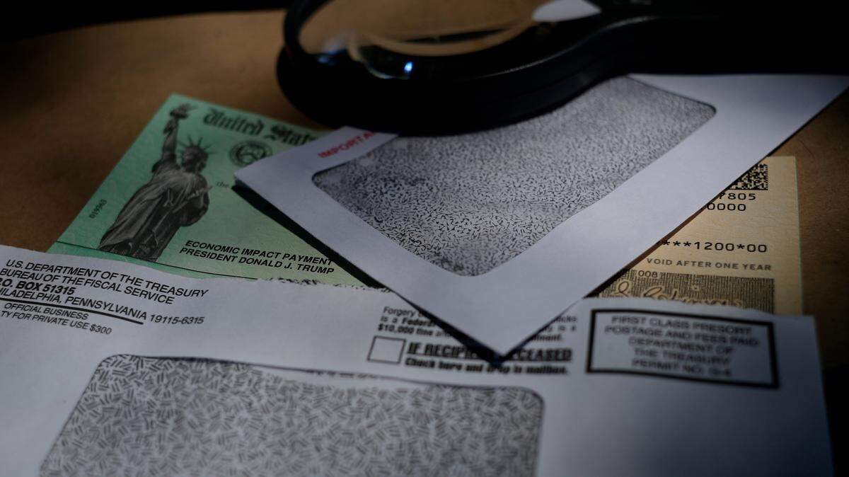 Former President Donald Trump’s name is seen on a stimulus check issued by the IRS to help combat the adverse economic effects of the COVID-19 outbreak, in San Antonio, Thursday, April 23, 2020. Those who don’t receive the third round of stimulus checks in their bank account by Wednesday should start checking the mail, the IRS says. (AP Photo/Eric Gay)