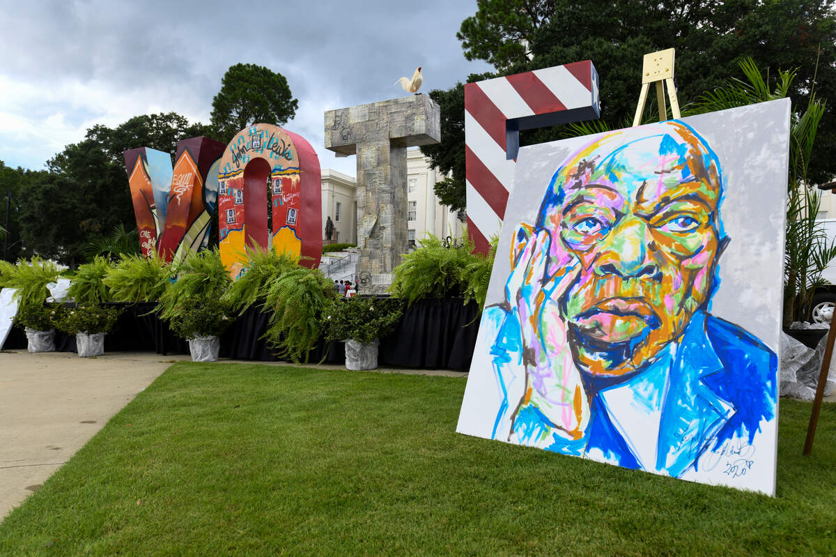 A portrait of Congressman John Lewis sets beside the stage before a memorial vigil Sunday, July 26, 2020, in Montgomery, Ala.(AP Photo/Julie Bennett)