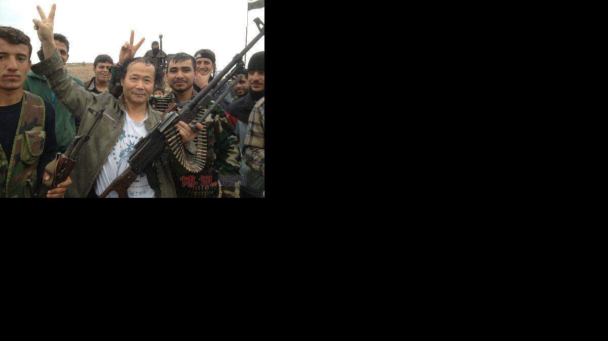 Chen Weiming is pictured with members of the Free Syria Army in 2012 in Syria, location unknown. Chen is a Chinese-born artist and naturalized New Zealand citizen who says he has made three trips to Syria since 2011 to fight with and help the FSA topple the Syrian government.
