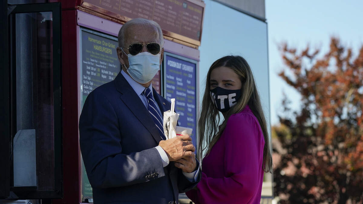 Democratic presidential candidate former Vice President Joe Biden and his granddaughter Finnegan order at the window at Cook Out in Durham, N.C., Sunday, Oct. 18, 2020. (AP Photo/Carolyn Kaster)