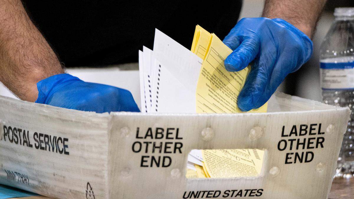 Fulton County Georgia elections workers process absentee ballots for the Senate runoff election in Atlanta on Tuesday, Jan. 5, 2021. (AP Photo/Ben Gray)