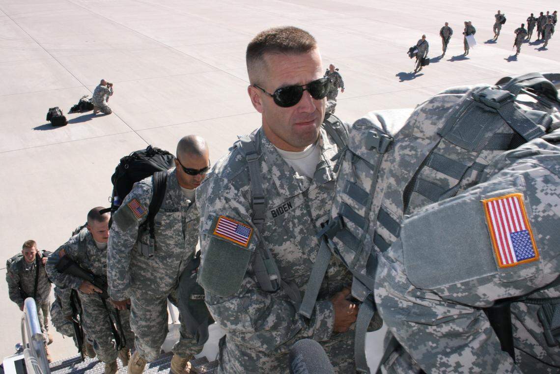 Maj. Beau Biden and fellow members of the Delaware Army National Guard, board a plane bound for Iraq in 2008. Biden, the son of president-elect Joe Biden, died in 2015 from a brain cancer his father thinks is tied to toxic exposure from burn pits at his base in Iraq.