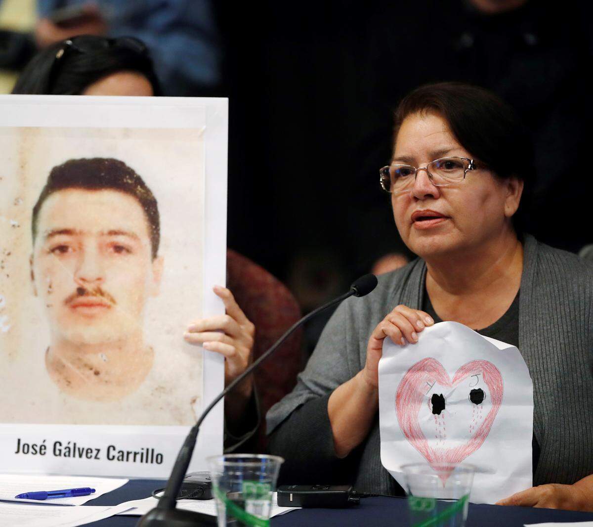 Irma Carrillo of Phoenix holds up a heart with two holes in it for her two children who have been missing since 1999, as she speaks during a hearing of the Inter-American Commission on Human Rights, on Oct. 5, 2018, at the University Colorado in Boulder, Colo. Human rights groups have been calling for greater use of DNA analysis to help families find missing loved ones in the U.S.-Mexico border region.