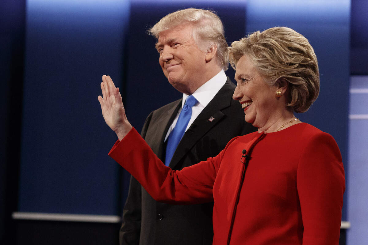 FILE - In this Sept. 26, 2016 file photo, then Republican presidential candidate Donald Trump, left, stands with then Democratic presidential candidate Hillary Clinton before the first presidential debate at Hofstra University in Hempstead, N.Y. Gearing up to take on Democratic front-runner Joe Biden, President Donald Trump sees echoes of his original political foe, Hillary Clinton. (AP Photo/ Evan Vucci)
