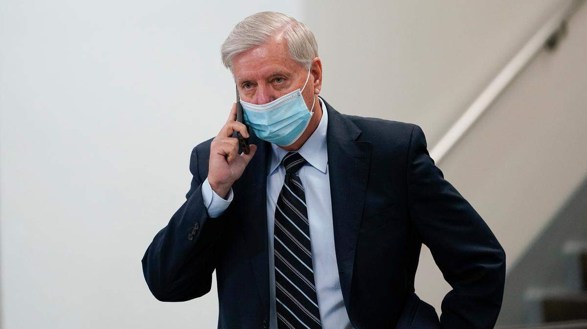 Sen. Lindsey Graham, R-S.C., talks on his cell phone as he walks on Capitol Hill in Washington, Wednesday, Feb. 10, 2021, during a break on the second day of the second impeachment trial of former President Donald Trump. Graham said Monday he’s “never felt better” about Trump leading the Republican party. (AP Photo/Susan Walsh)