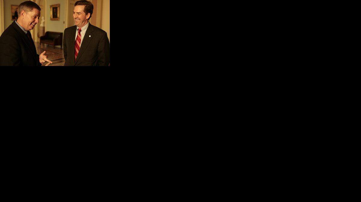 South Carolina Republican Senators Lindsey Graham and Jim DeMint outside the Senate Floor in the US Capitol, Nov. 17, 2005.