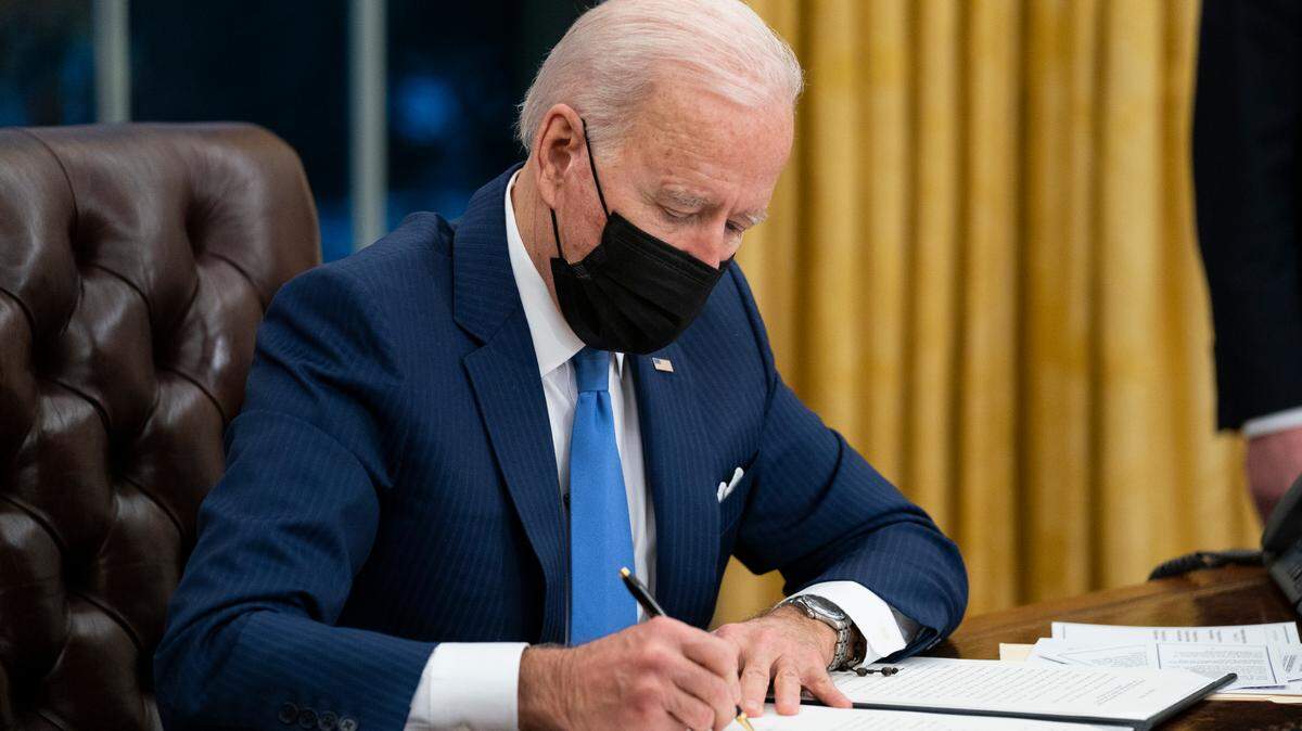 President Joe Biden signs an executive order on immigration, in the Oval Office of the White House, Tuesday, Feb. 2, 2021, in Washington. Some adovactes are pushing his administration to do more. (AP Photo/Evan Vucci)