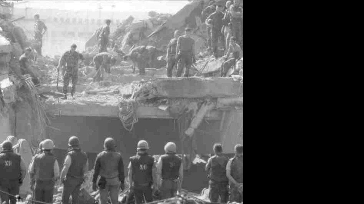 Rescue and clean-up crews search for casualties following the barracks bombing in Beirut, Oct 23, 1983.