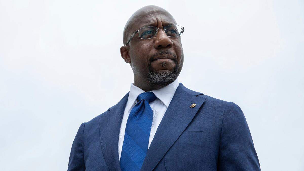 Sen. Raphael Warnock, D-Ga., speaks to reporters about voting rights legislation on Capitol Hill in Washington, Tuesday, Aug. 3, 2021. Warnock’s campaign said Wednesday, Jan. 26, 2022, that he raised a hefty $9.8 million in the last quarter of 2021, nearly double the fundraising reported by the leading Republican contender for his seat, former football star Herschel Walker.