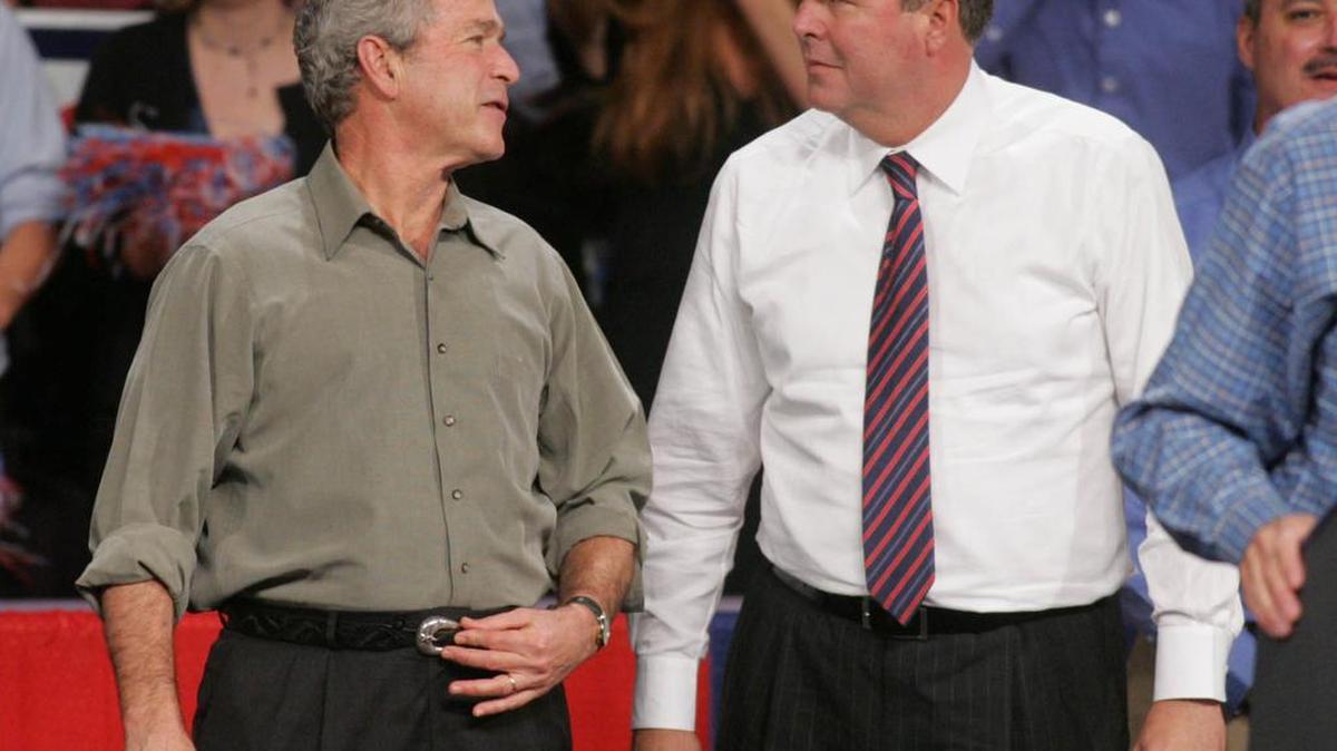 FILE - In this Nov. 6, 2006, file photo, President George W. Bush jokes with his brother Florida Gov. Jeb Bush in Pensacola, Fla., where the president was drumming up support for local Republican candidates. Jeb Bush is summoning his brother, former President George W. Bush, to campaign for him in South Carolina. It’s not without risks, but the Bush family has long, deep political ties in the state, and the former Florida governor has little choice if he wants to join his father and brother as Oval Office occupants.
