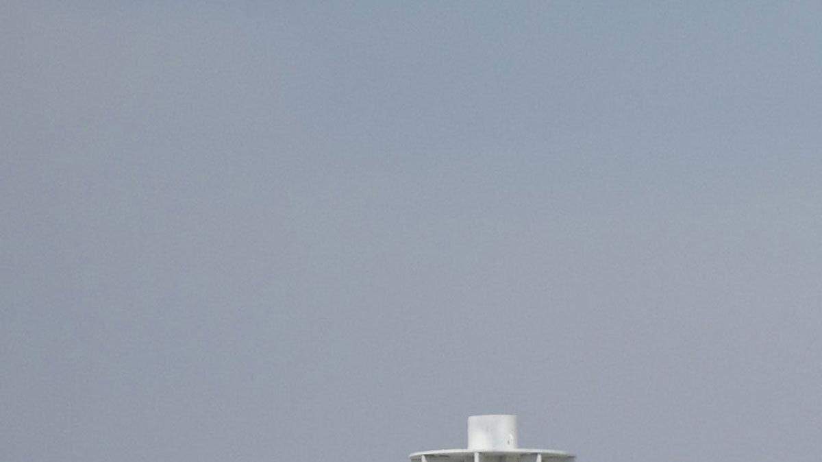 Men paint an oil containment dome at Port Fourchon, Louisiana, on Tuesday, on Tuesday, May 11, 2010. The first containment dome dropped over an oil leak in the Gulf of Mexico did not stop the leak. (Travis Heying/Wichita Eagle/MCT)