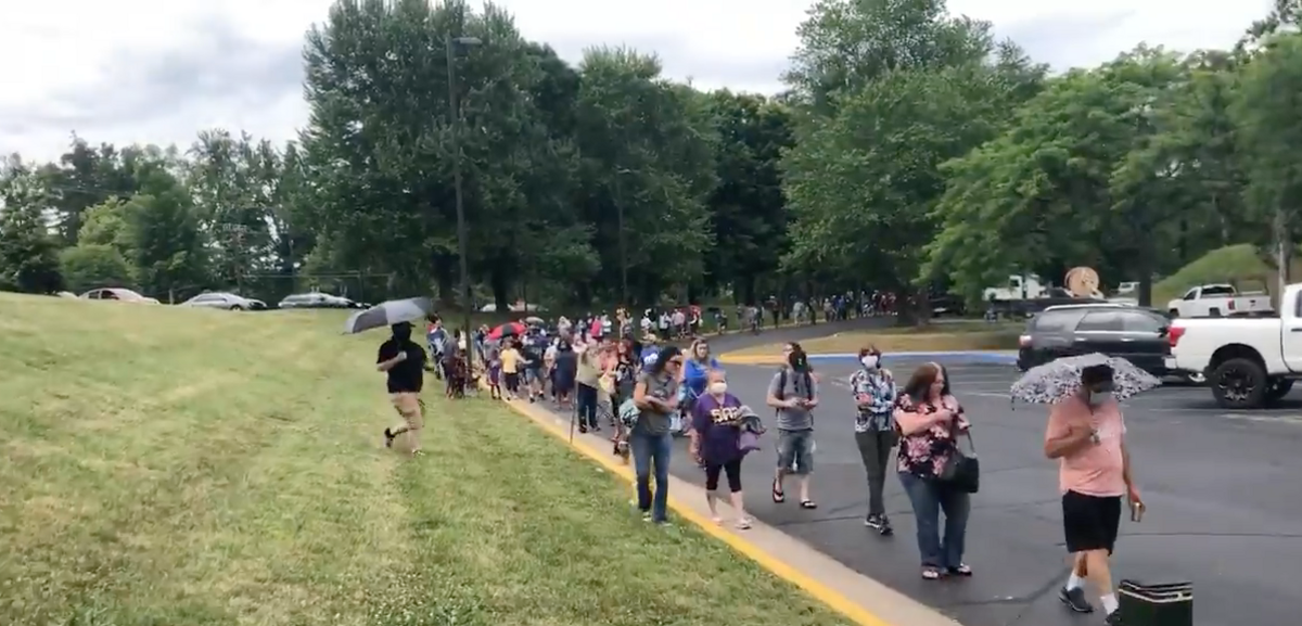 People wait for unemployment help in a long line in Lexington, Ky.