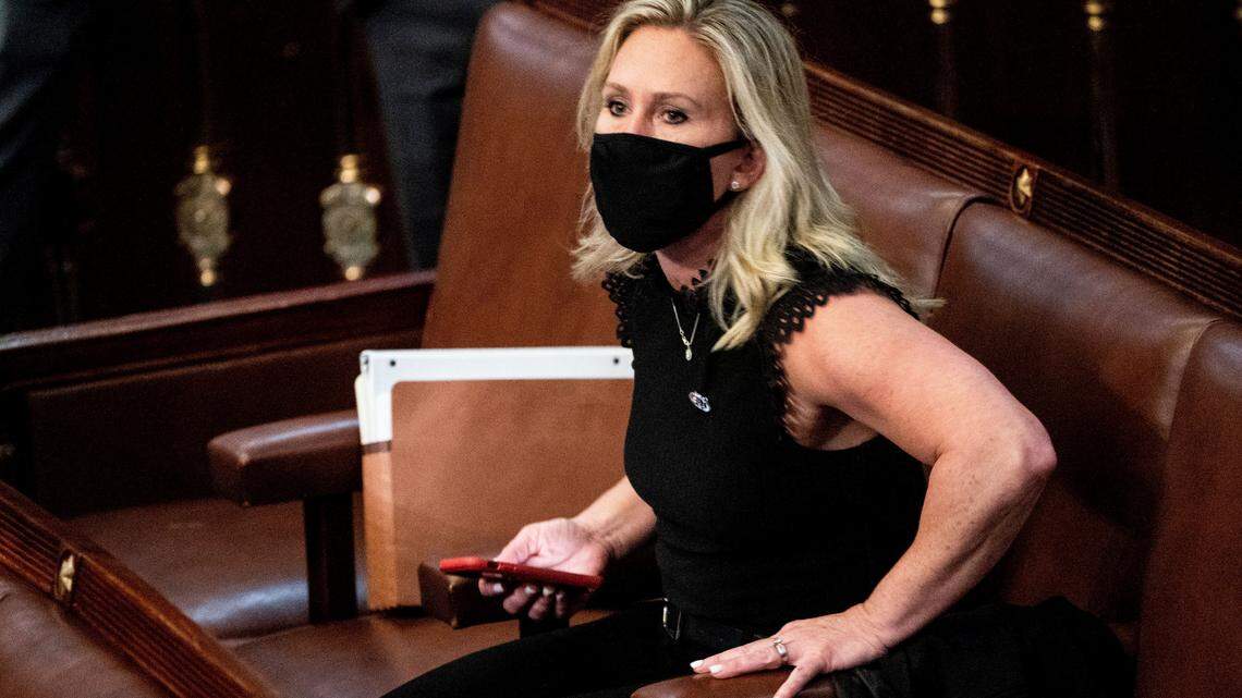 In this Jan. 6, 2021, file photo, Rep. Marjorie Taylor Greene, R-Ga., sits in the House Chamber after they reconvened for arguments over the objection of certifying Arizona’s Electoral College votes in November’s election, at the Capitol in Washington.