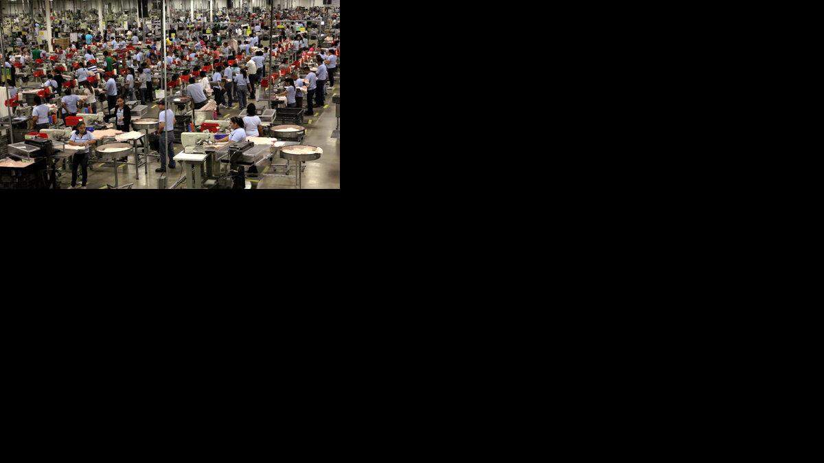 Employees work the production line at a factory in Ciudad Acuna, Coahuila state, Mexico.