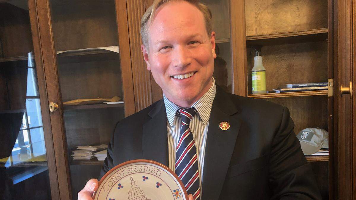 Rep. Steve Watkins, R-Kansas, shows off a commemorative plate given to him by Rep. Steve Scalise, R-Louisiana, one of the few decorations in his Capitol Hill office.