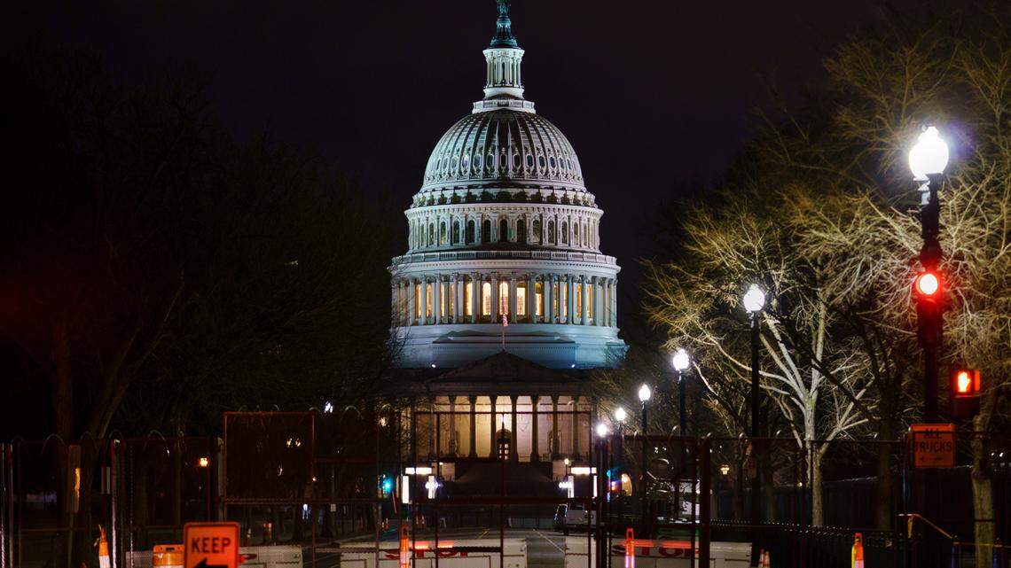 The Capitol is seen behind reinforced barricades as the second impeachment trial of former President Donald Trump begins in the Senate in Washington, Tuesday, Feb. 9, 2021. (AP Photo/J. Scott Applewhite)