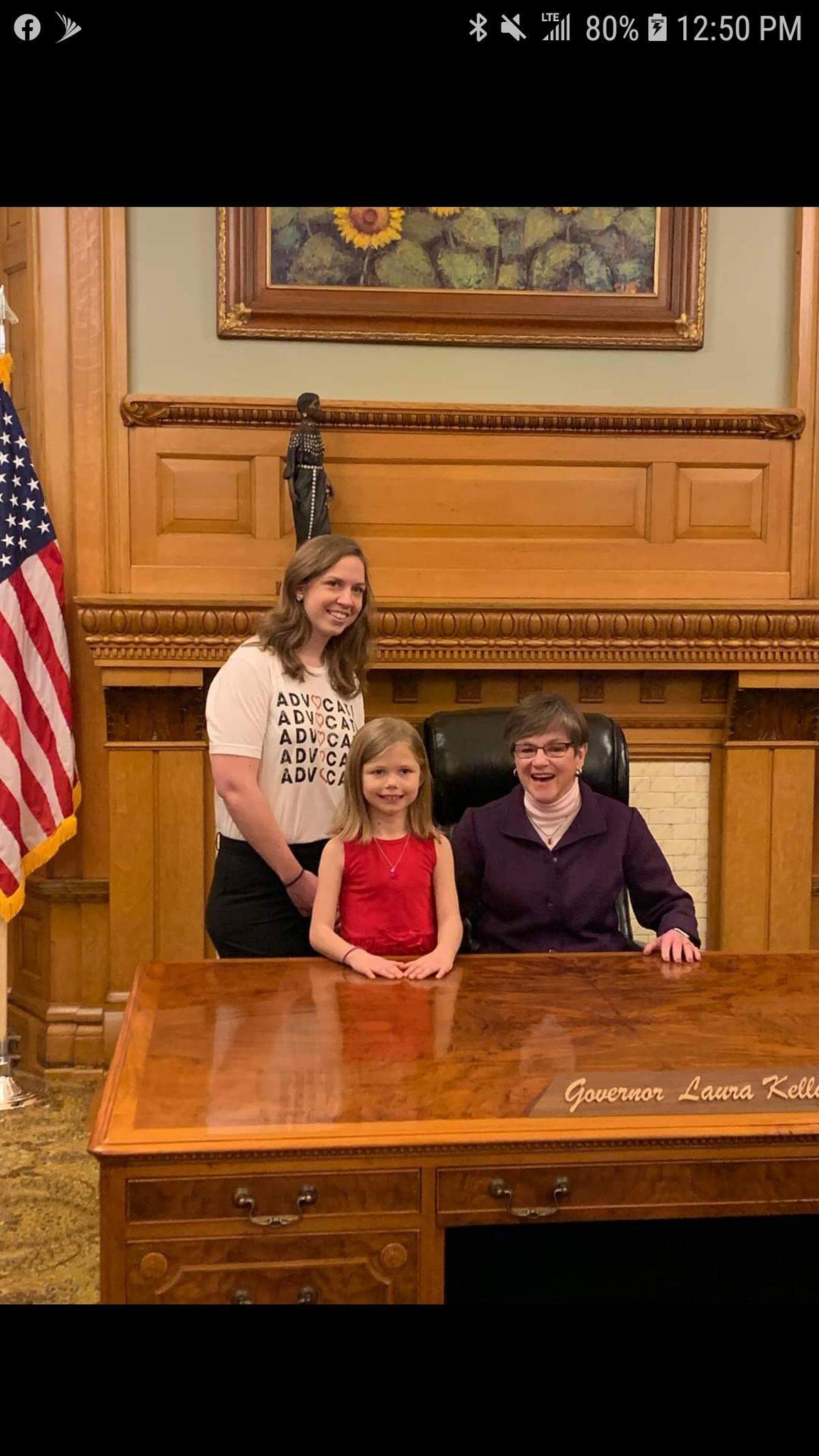 Melissa Dodge, 35, an uninsured woman from Derby, and her daughter Brooklynn, 9, pose for a photo with Kansas Gov. Laura Kelly.