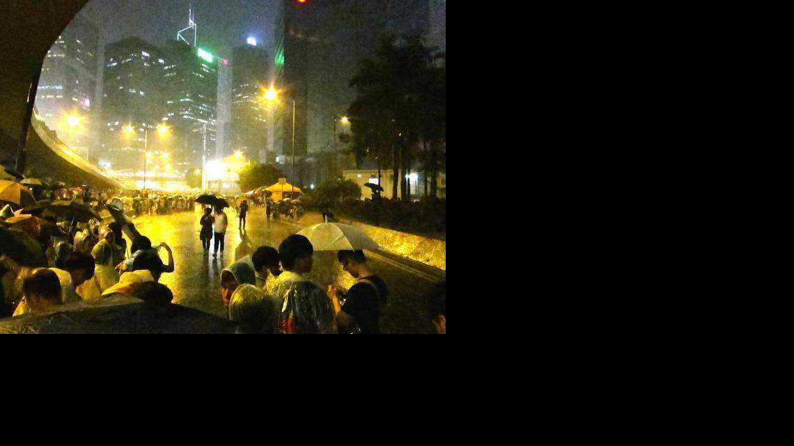 Hong Kong protesters, dubbed the 'umbrella revolution,' needed those umbrella during a lightening storm Tuesday, Sept. 30, 2014. The storm cracked lightning directly overhead Hong Kong's government complex, where these demonstrators had gathered. Stuart Leavenworth/McClatchy
